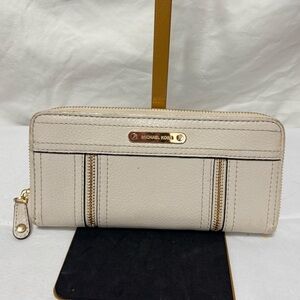 Michael Kors Moxley continental zip-around wallet in vanilla or cream leather.
